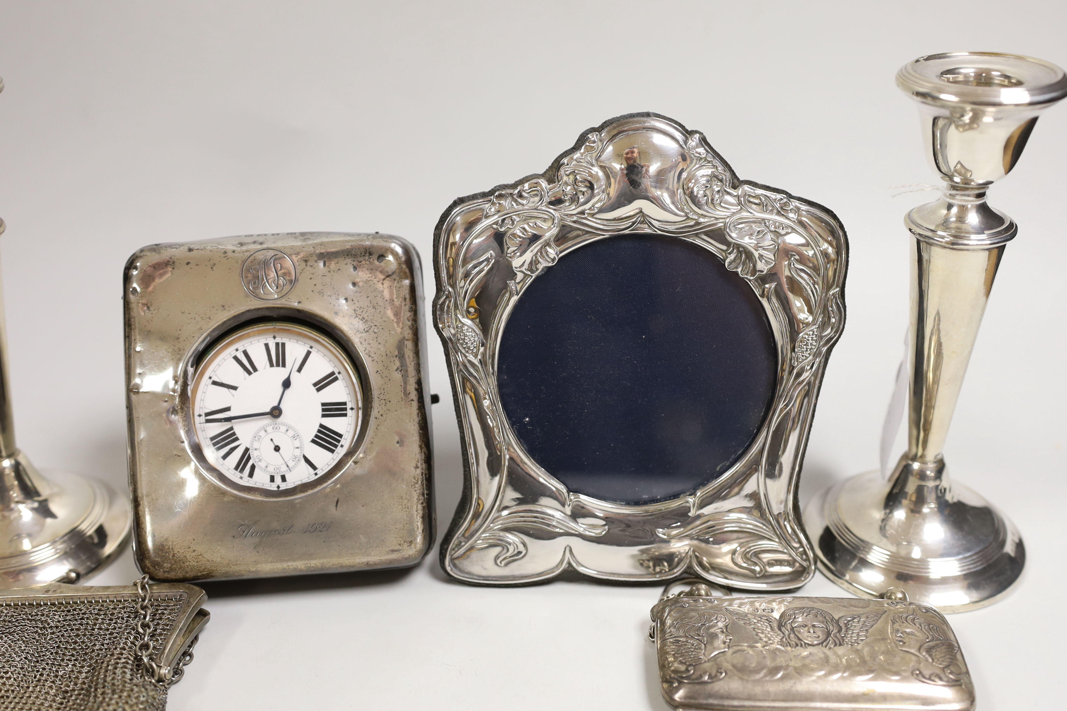 Mixed silver including a pair of George V mounted candlesticks, London, 1919, 17.4cm, travelling pocket watch case, purse, mesh bag and a modern photograph frame.